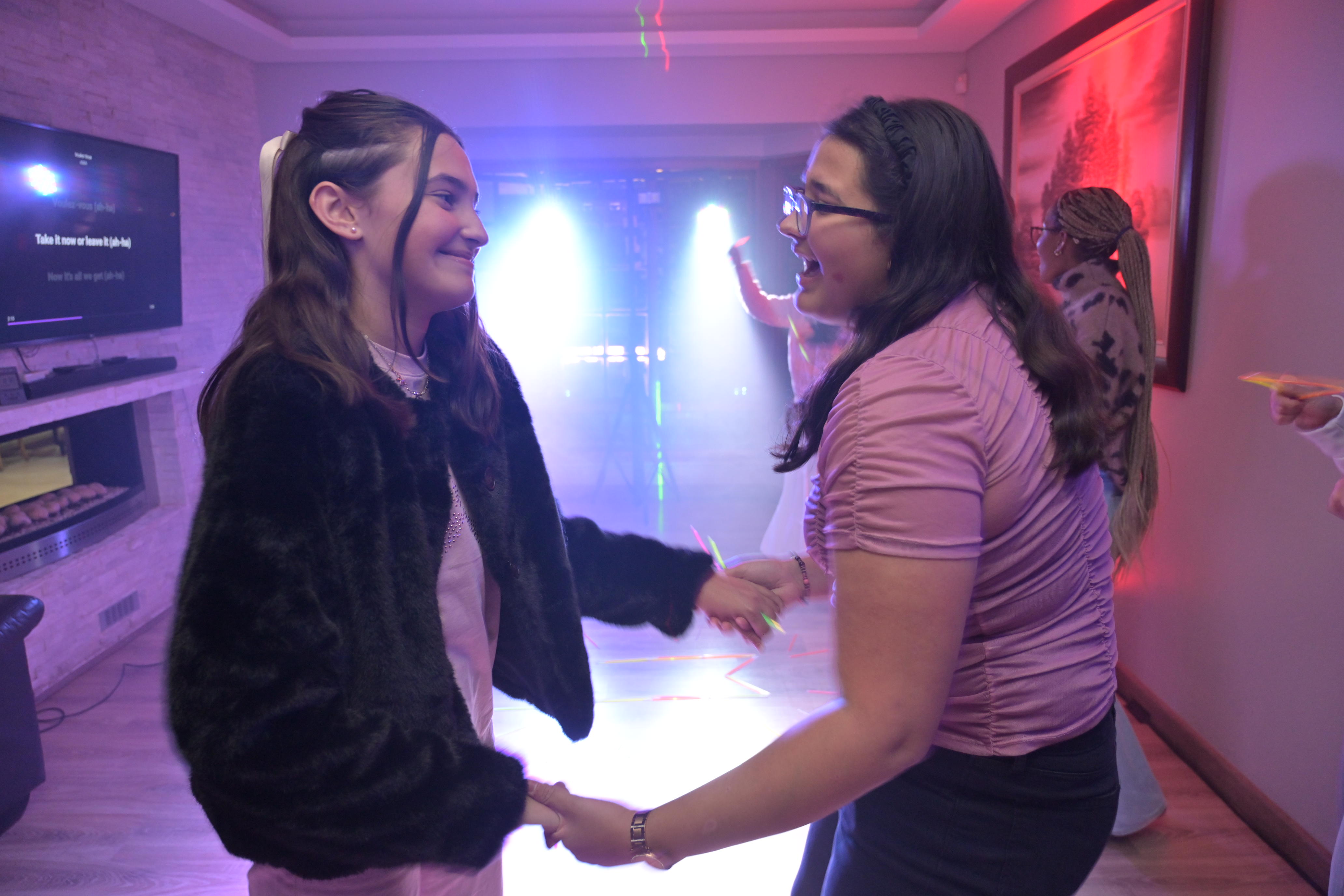 Two sisters dancing at a birthday party